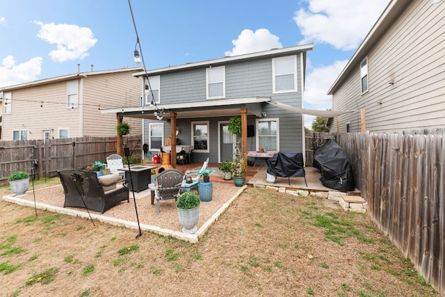 rear view of house with a patio area, an outdoor fire pit, and a fenced backyard