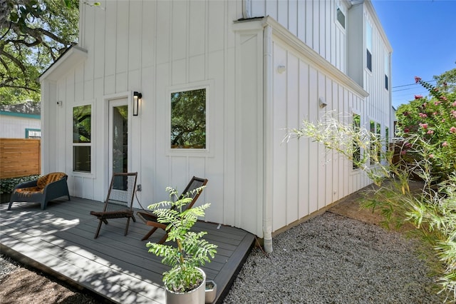 exterior space featuring board and batten siding and a deck