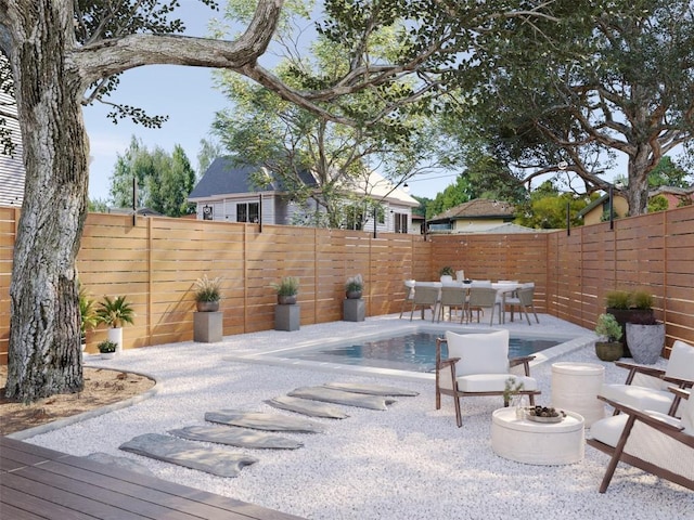 view of pool featuring a patio, outdoor dining area, a fenced backyard, and a fenced in pool