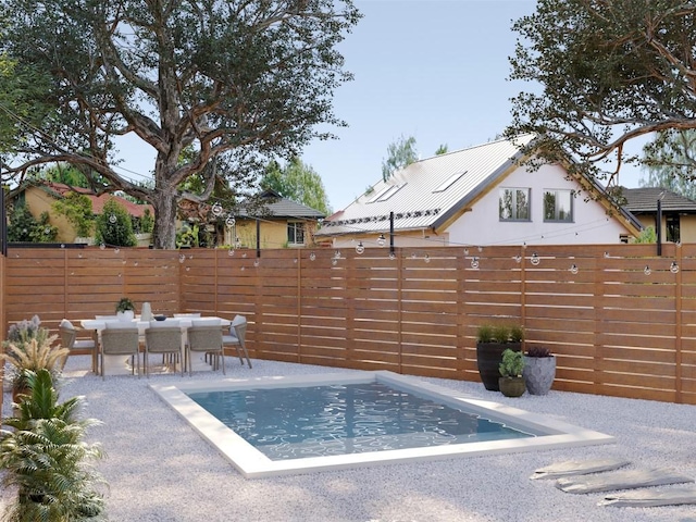 view of pool with a patio, outdoor dining area, and a fenced backyard