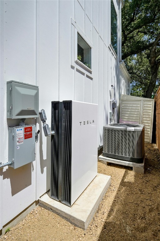 exterior space featuring cooling unit and board and batten siding