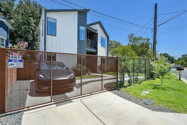 view of gate with a yard