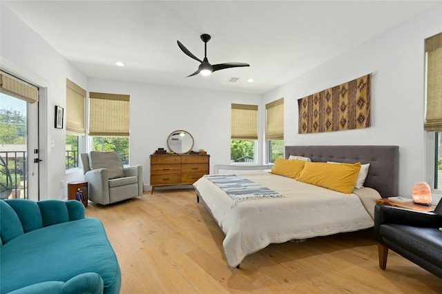 bedroom with recessed lighting, multiple windows, light wood-style floors, and access to outside