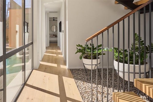 hall with wood finished floors and baseboards