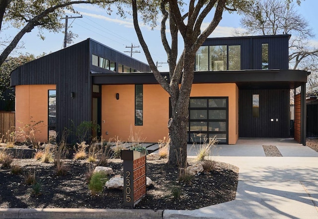 contemporary home with a garage and concrete driveway