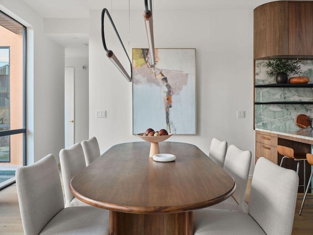 dining area with wood finished floors