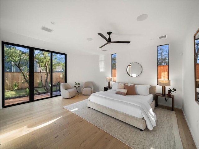 bedroom featuring access to exterior, visible vents, ceiling fan, and wood finished floors