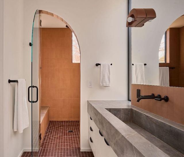 bathroom with a stall shower, tile patterned flooring, and vanity