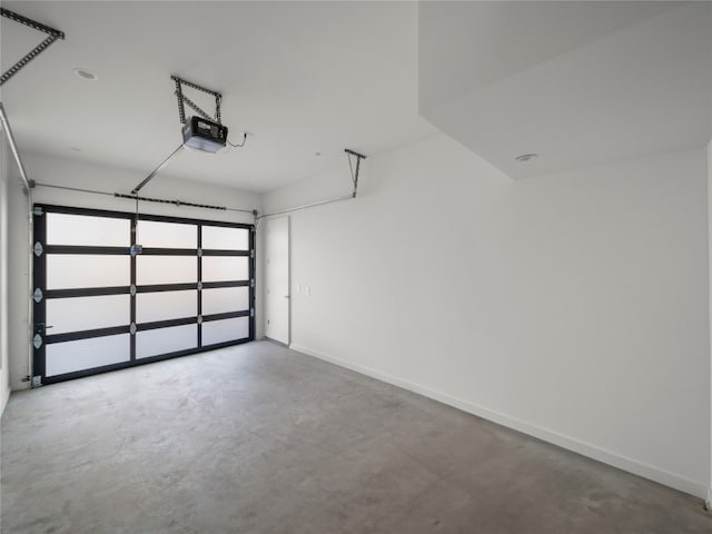 garage featuring baseboards and a garage door opener