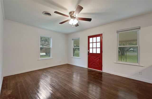 entryway with crown molding, wood finished floors, visible vents, and baseboards