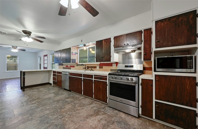 10309 Wommack Rd, Austin, TX 78748 - kitchen with appliances with stainless steel finishes, a ceiling fan, under cabinet range hood, light countertops, and dark brown cabinets