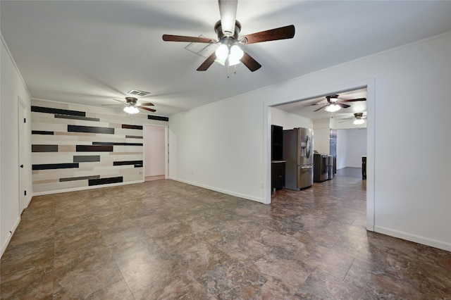 empty room with crown molding, visible vents, and baseboards