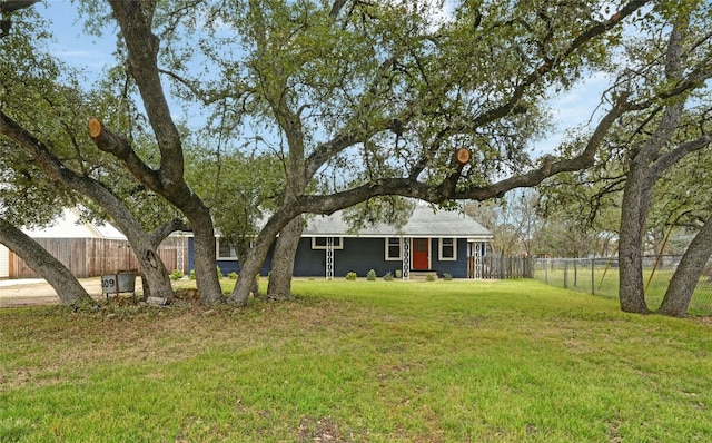 ranch-style house with a front lawn and fence