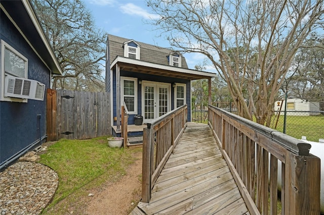 rear view of house with a yard, cooling unit, french doors, and fence