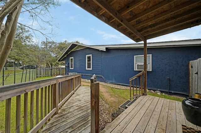 wooden terrace featuring a yard and fence