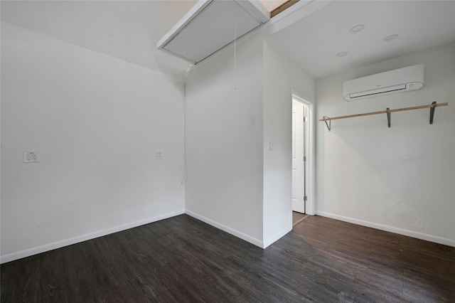 10309 Wommack Rd, Austin, TX 78748 - empty room featuring attic access, a wall mounted air conditioner, and wood finished floors