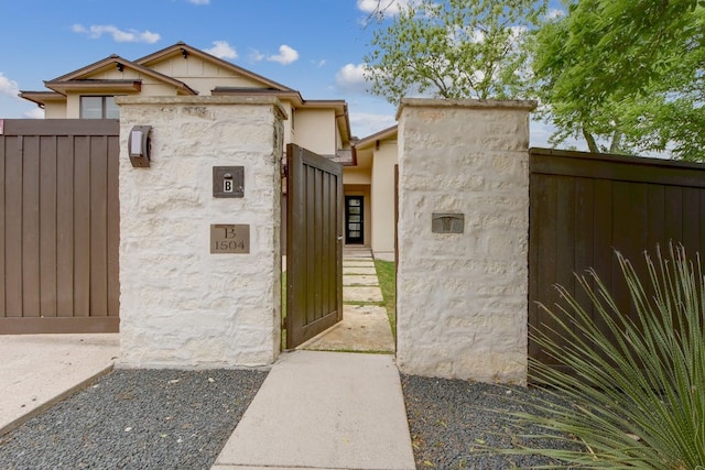 view of gate with a fenced front yard