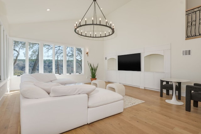 living area with recessed lighting, a chandelier, visible vents, wood finished floors, and high vaulted ceiling