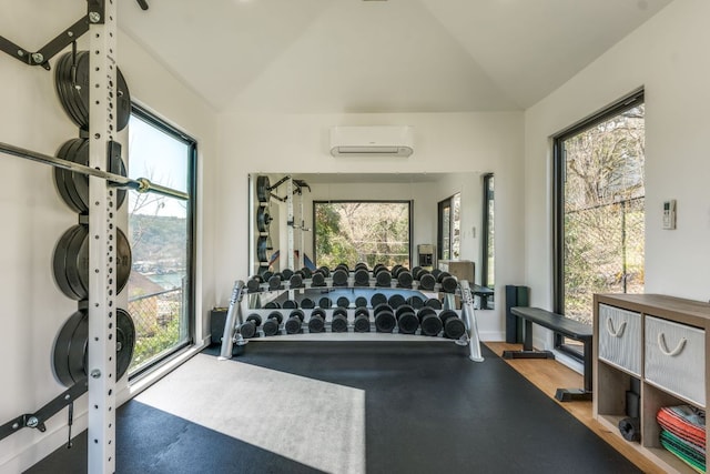 workout area with vaulted ceiling and a wall mounted air conditioner