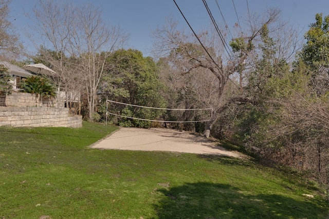 view of community featuring a lawn and volleyball court