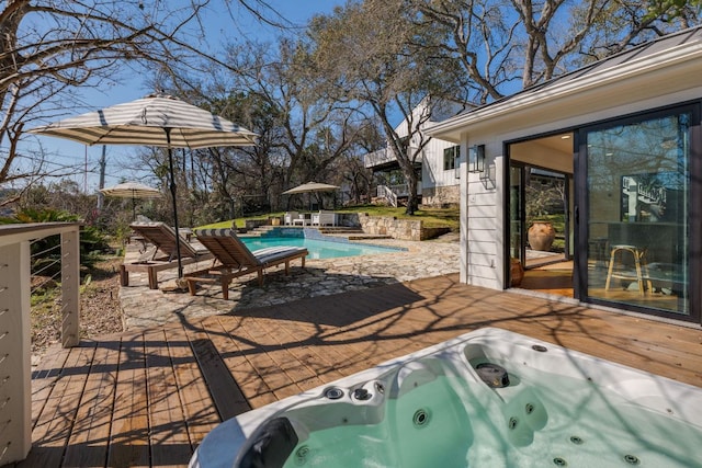 view of patio / terrace with hot tub deck surround and an outdoor pool