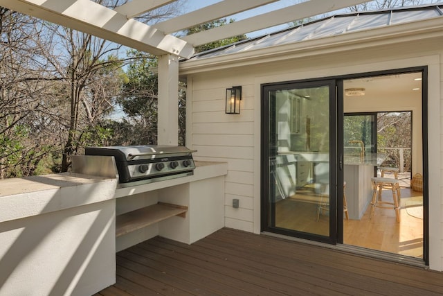 wooden terrace featuring a grill, a pergola, and area for grilling