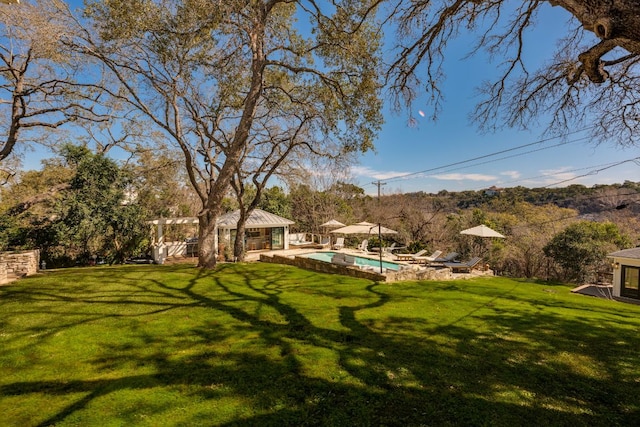 view of yard featuring an outbuilding, a patio area, and an outdoor pool