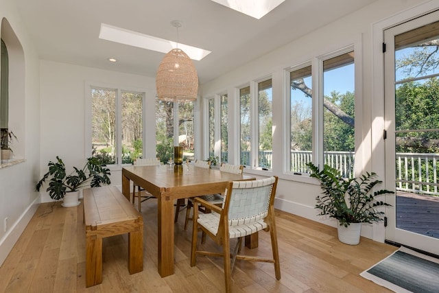 sunroom / solarium with arched walkways and a skylight