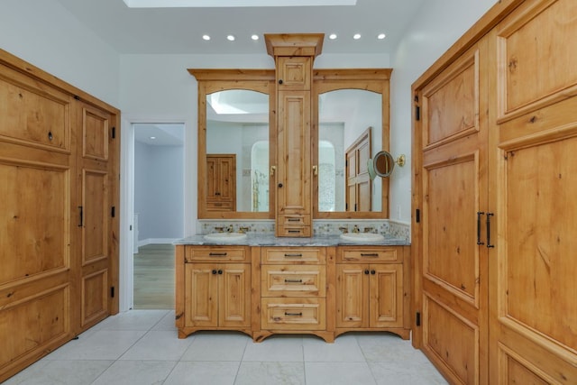 full bath featuring double vanity, tile patterned floors, a sink, and recessed lighting