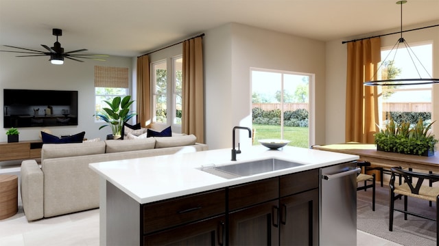 kitchen featuring dishwasher, light countertops, open floor plan, and a sink