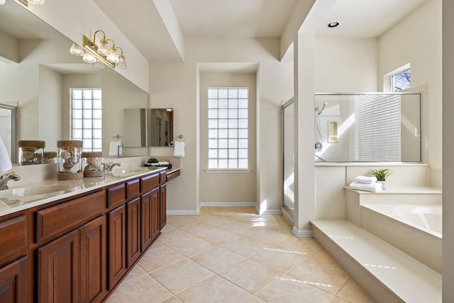 bathroom featuring tile patterned flooring, a sink, and a shower stall