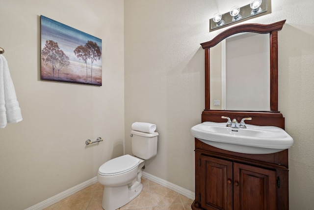 half bath featuring toilet, tile patterned flooring, baseboards, and vanity