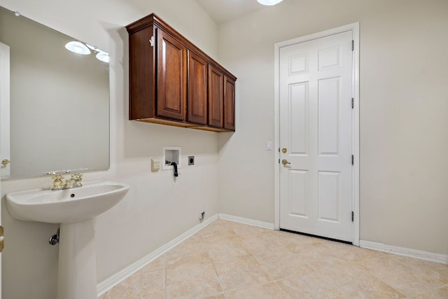 washroom with light tile patterned floors, cabinet space, baseboards, hookup for an electric dryer, and washer hookup