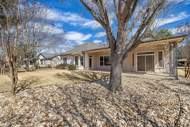 back of property featuring a patio and stucco siding