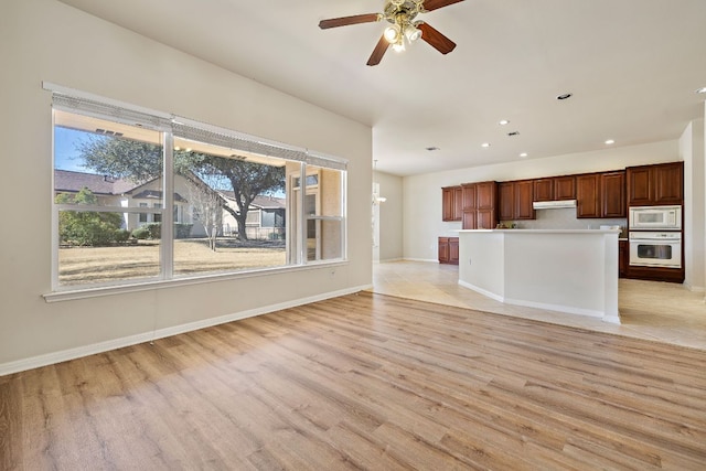 unfurnished living room featuring light wood finished floors, ceiling fan, baseboards, and recessed lighting