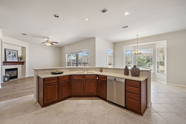 kitchen featuring a sink, visible vents, stainless steel dishwasher, and light tile patterned flooring