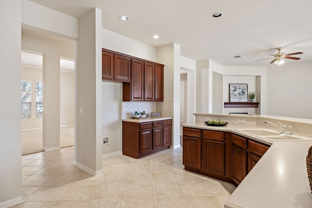 kitchen featuring light tile patterned floors, recessed lighting, a sink, light countertops, and decorative backsplash