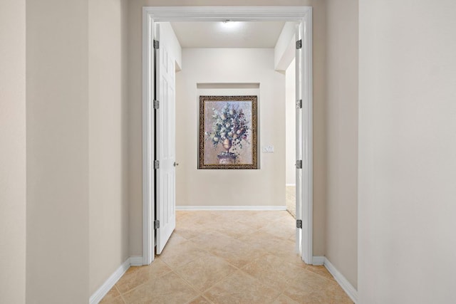 hall featuring baseboards