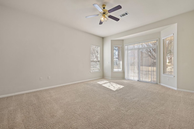 unfurnished room featuring a ceiling fan, carpet flooring, visible vents, and baseboards