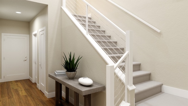 stairs with baseboards and wood finished floors