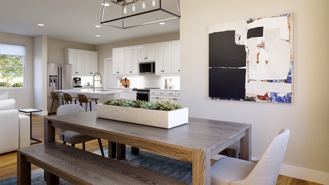 dining area featuring recessed lighting, baseboards, and wood finished floors