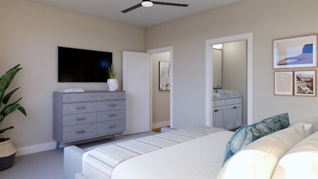 bedroom with ensuite bath, baseboards, ceiling fan, and carpet flooring