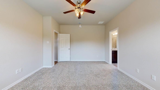 unfurnished bedroom featuring visible vents, baseboards, connected bathroom, light colored carpet, and ceiling fan