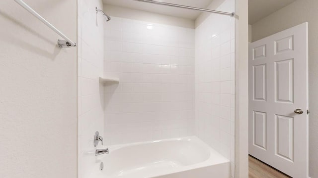 full bathroom featuring washtub / shower combination and wood finished floors