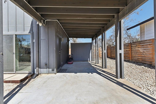 view of patio featuring an attached carport and fence