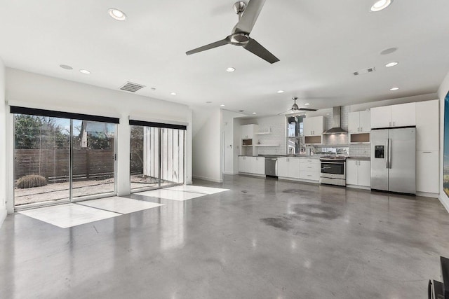 unfurnished living room featuring recessed lighting, visible vents, and finished concrete flooring