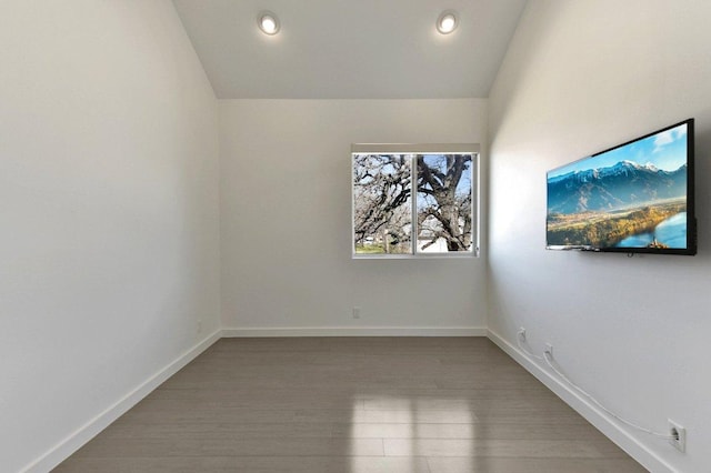 spare room with recessed lighting, baseboards, and wood finished floors