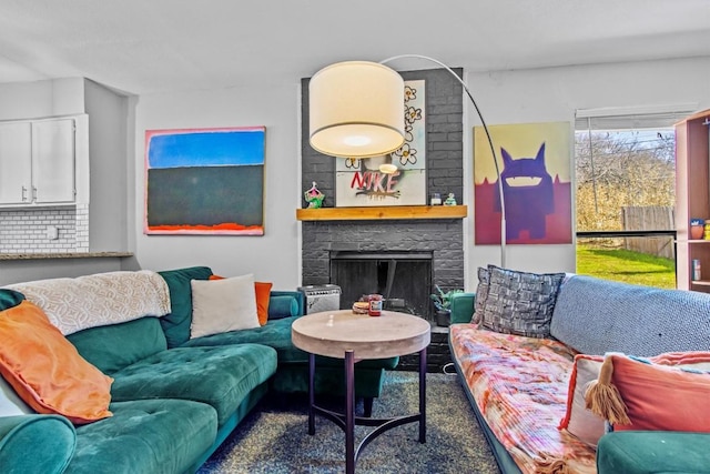 living room featuring a stone fireplace