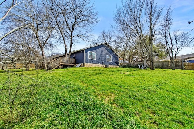 view of yard featuring fence and a wooden deck