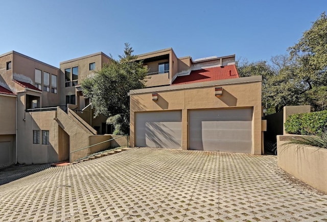 modern home featuring a garage and stucco siding